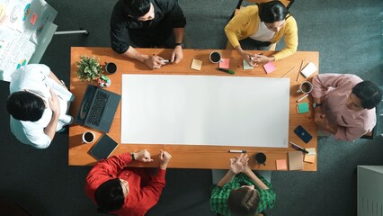 Time lapse of diverse business team designing and planning project while skilled project manager walking and joining meeting at meeting table with sticky notes and laptop at boardroom. Convocation.