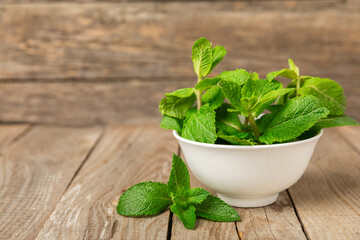 Mint. Fresh organic mint leaves on wooden background. Mint leaves. Peppermint. Close-up. Space for text. Copy space.