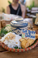 Vegan meal with inspiring sign on rustic table, promoting healthy lifestyle and harmony, Plantbased dish with motivational text on wooden surface, encouraging wellness and balance