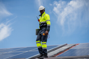 Service engineer checking solar cell on the roof for maintenance if there is a damaged part....