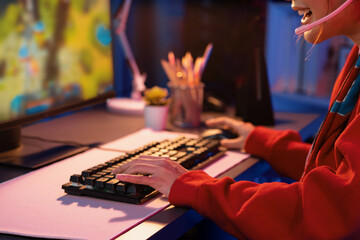 Host channel of young beautiful Asian gaming streamer playing fighting Moba at battle arena game on...