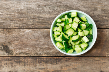 Cucumber on wooden background. Slice of cucumber on background. Fresh organic green cucumbers...