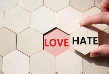 Love vs Hate symbol. Concept word Love vs Hate on wooden comb puzzle. Businessman hand. Beautiful...