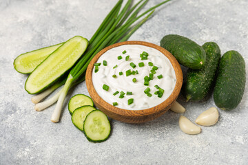 Cucumber sour cream tzatziki sauce on a wooden table.Tartar sauce. Traditional delicious appetizer....