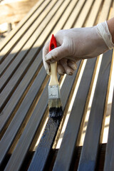 Painting Metal Surface with Brush and Protective Gloves