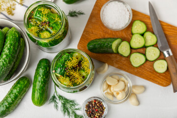 Freshly-salted homemade cucumbers in a jar on a wooden background. pickled cucumbers with dill,garlic and pepper.canned cucumbers.cucumbers and dill.Recipe of homemade preservations.fermented veggies.