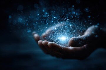 Glowing blue sphere of light particles floats gently above outstretched hands in a darkened environment creating a mystical atmosphere