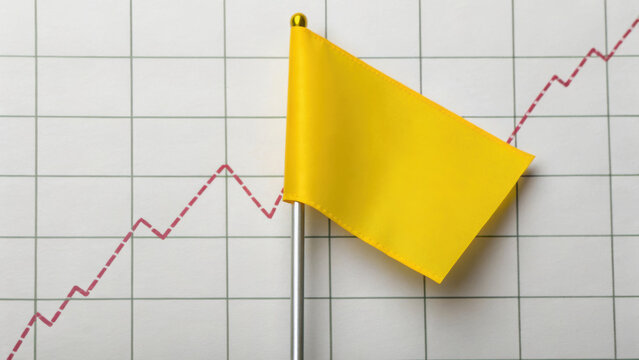 Yellow flag is placed on financial graph with sharp dip, symbolizing caution in market trends. graph red line indicates fluctuations, highlighting potential risks - Powered by Adobe