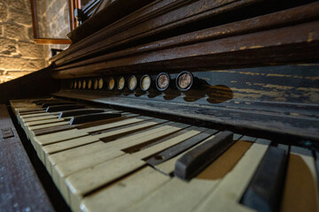 Close-up of vintage piano keys with worn texture, evoking nostalgia and timeless musical beauty