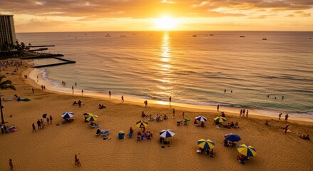 Beach scene at sunset with people ocean waves and building silhouette.