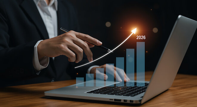 Business professional working with a laptop to analyze projected financial growth and future success