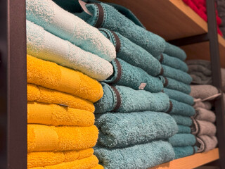 Stacked Multicolor Towels on Industrial Wooden Shelves, Pastel and Bold Textile Harmony