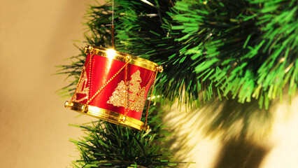 Christmas New Year decoration with red drums in the background of tinsel garlands
