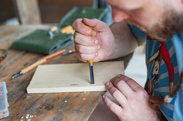 A man carving wood with chisels. Creativity, hobby
