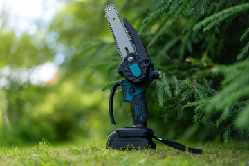 Mini cordless chain saw garden.Saw with lithium batteries.