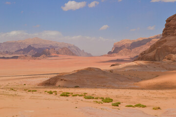 Wadi Rum desert in Jordan and beautiful red mountains captured on a warm spring day.