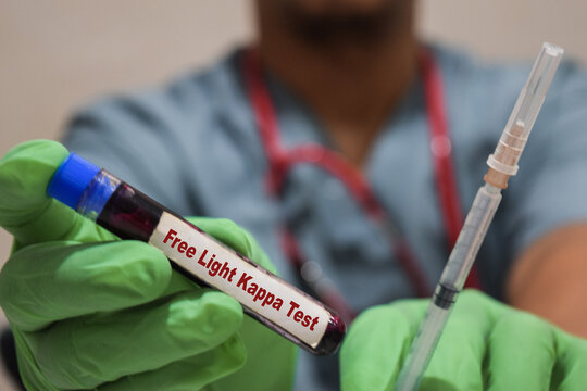 Text Free Light Kappa Test of is written on a bottle sample with background of a doctor with a syringe in a medical glove mask. Medical concept