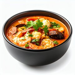 Aromatic seafood gumbo brimming with shrimp and sausage in a dark bowl on white background