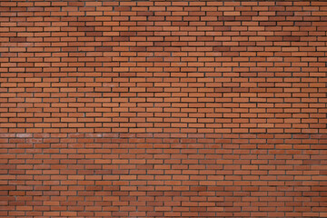 Red brick wall displaying uniform patterns and textures, a simple backdrop for various settings and...
