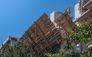 Security measures taken on the exterior of the building with protective wooden panels.	