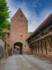 Fototapeta premium View of Trausnitz castle medieval castle gate, made of brick with wooded machicolations to protect the defenders