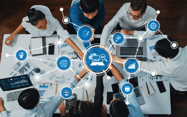 A diverse group of professionals engaged in a dynamic business meeting focused on data analysis and SEO strategy implementation. The scene showcases teamwork and collaboration. Amity