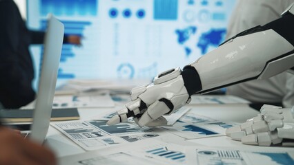 A robotic arm interacts with various data charts and graphs on a desk, showcasing the blend of...