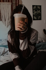 Woman Holding Iced Coffee Indoors