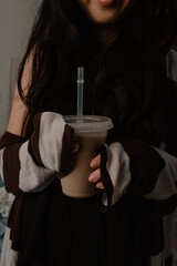 Woman Holding Iced Coffee in Plastic Cup