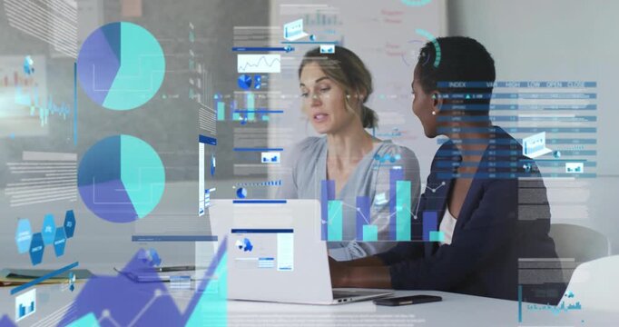 Two professional women pointing at laptop line graph, initiating animated charts for data analysis