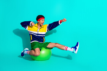 Youthful athlete practicing retro workout moves while enjoying fun fitness routines against a...