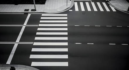 Striking monochrome road intersection featuring pedestrian crossing and lane markings