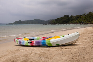 Fototapeta premium Colorful kayak on the sandy beach against the sea in Thailand