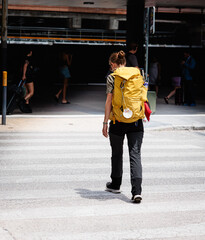 Pilgrim walking on crosswalk near train station En Route to Camino Santiago