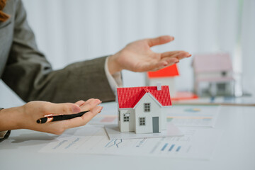 close up asian business man holding model house, business finance, investment, real estate concept