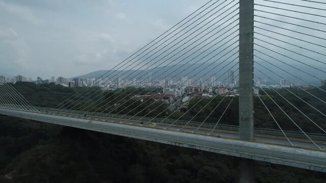 Aerial view of the Viaducto Provincial in Bucaramanga, Colombia. A modern bridge connecting the city, with visible traffic and contemporary architecture, surrounded by urban and mountainous landscape.