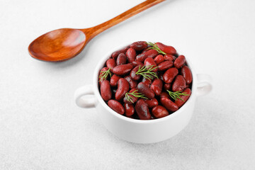 Red kidney beans  in white bowl for vegan, healthy eating or rustic food concept