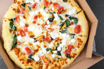 Fresh baked pizza with vegetables and cheese in delivery box for fast food, lunch or restaurant delivery concept