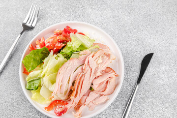 Flatlay of turkey salad on soft pastel with cutlery for recipe website or app UI concept