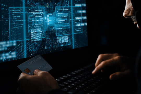 Criminal anonymous male approaching credit card of personal information database for codding encryption scam program in privacy system at night time at blue neon light room with server drive. Surmise.