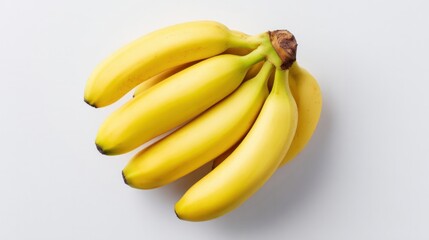 Top view of a cluster of yellow bananas placed on a white background