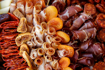 Delectable array of cured meats and dried fruits at a culinary event