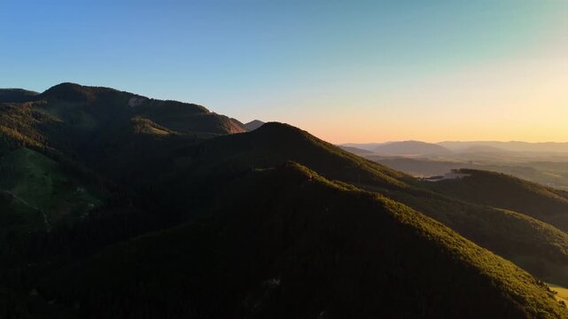 Stunning verdant mountains covered by pine tree woods at the time of sunset. Beautiful Tatra mountains in Slovakia from aerial view.