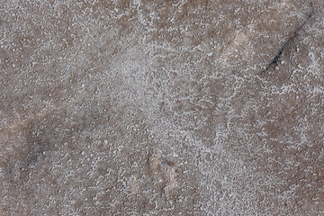 Top-down view of deserted terrain with white dried salt spots. Dry cracked land covered with salt. Kalmykia, Russia