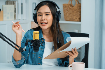 Host channel Asian influencer talking in broadcast streaming online wearing headset on social media...