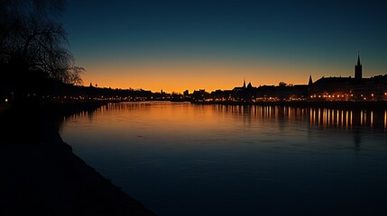 Fototapeta premium City skyline reflected on tranquil river at dusk