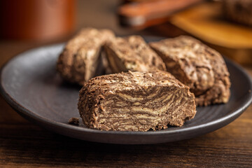 Halva with cocoa. Sweet oriental dessert on plate.
