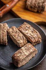 Halva with cocoa. Sweet oriental dessert on plate.