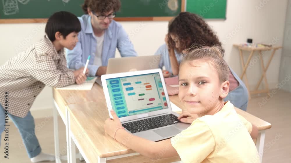 Poster cute caucasian boy coding program and looking at camera in stem technology class while group of dive