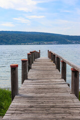Wooden pier overlooking the Alps and Lake Constance in Switzerland
